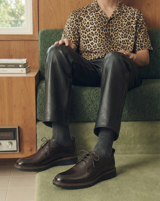 Professional wearing brown Derby shoes with leopard print shirt and leather trousers showing versatile styling